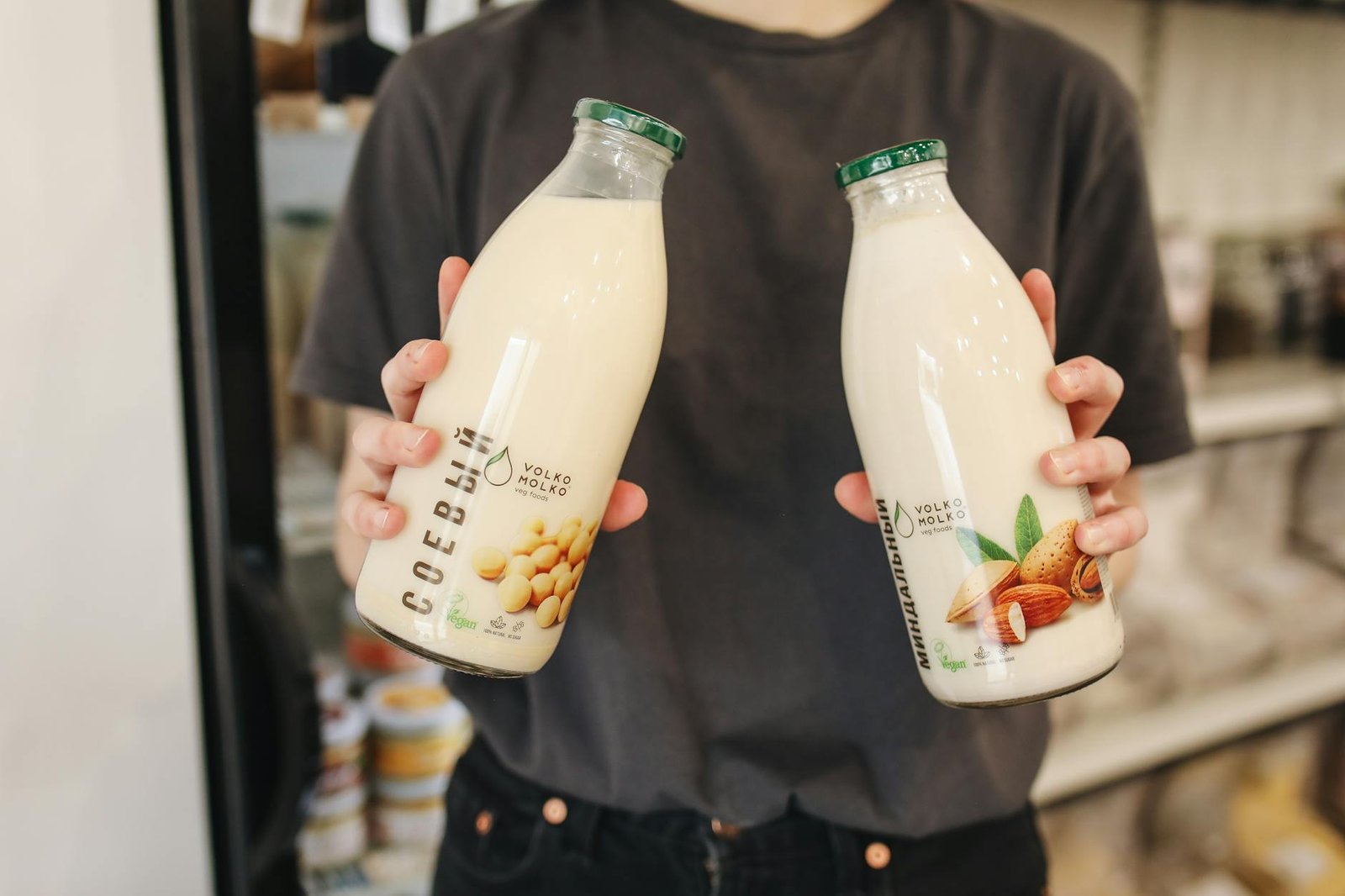 Lactose Free Milk - Health - person holding bottles with milk person holding bottles with milk