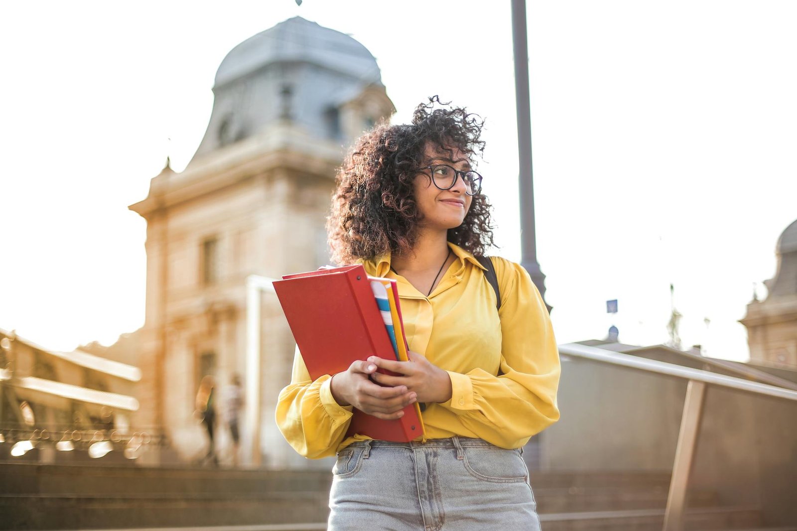 Leadership Skills in Students - Behavior - woman in yellow jacket holding books woman in yellow jacket holding books