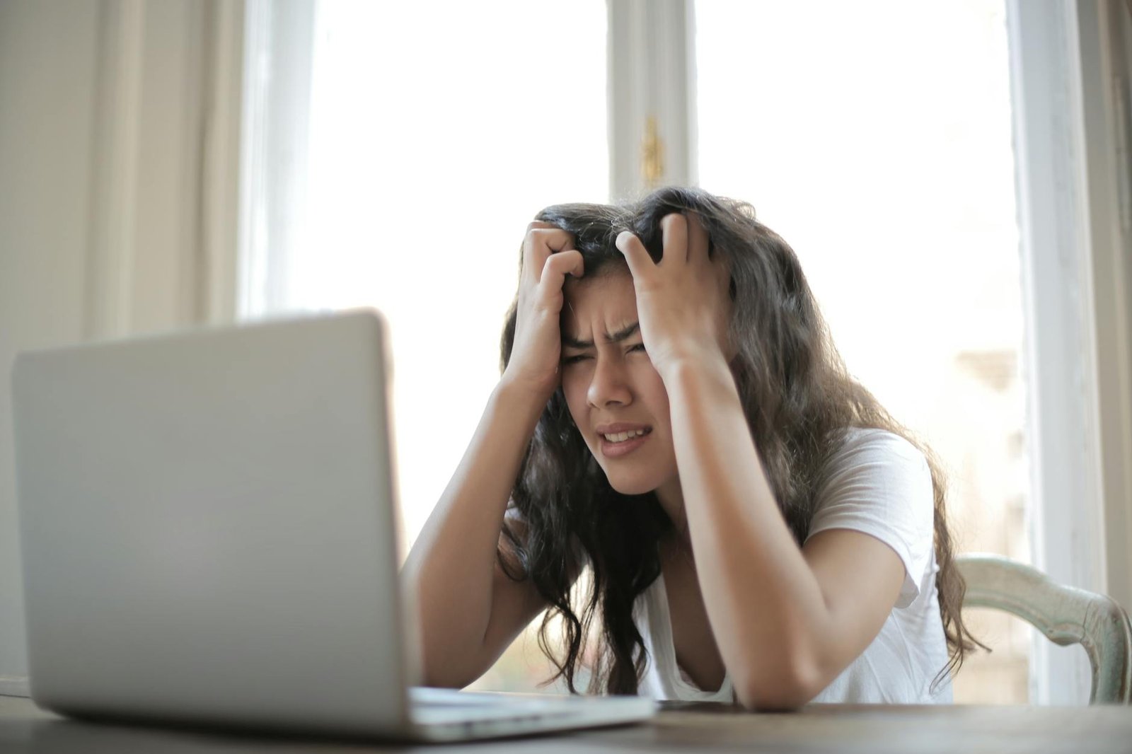 stress effects on health - Mental Health - woman in white shirt showing frustration woman in white shirt showing frustration
